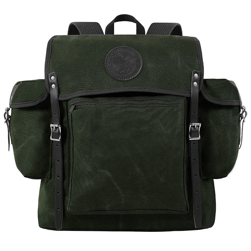 Rambler backpack in olive drab with black leather straps, featuring durable canvas construction and spacious pockets for rugged outdoor use by Duluth Pack.