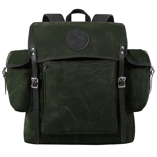 Rambler backpack in olive drab with black leather straps, featuring durable canvas construction and spacious pockets for rugged outdoor use by Duluth Pack.
