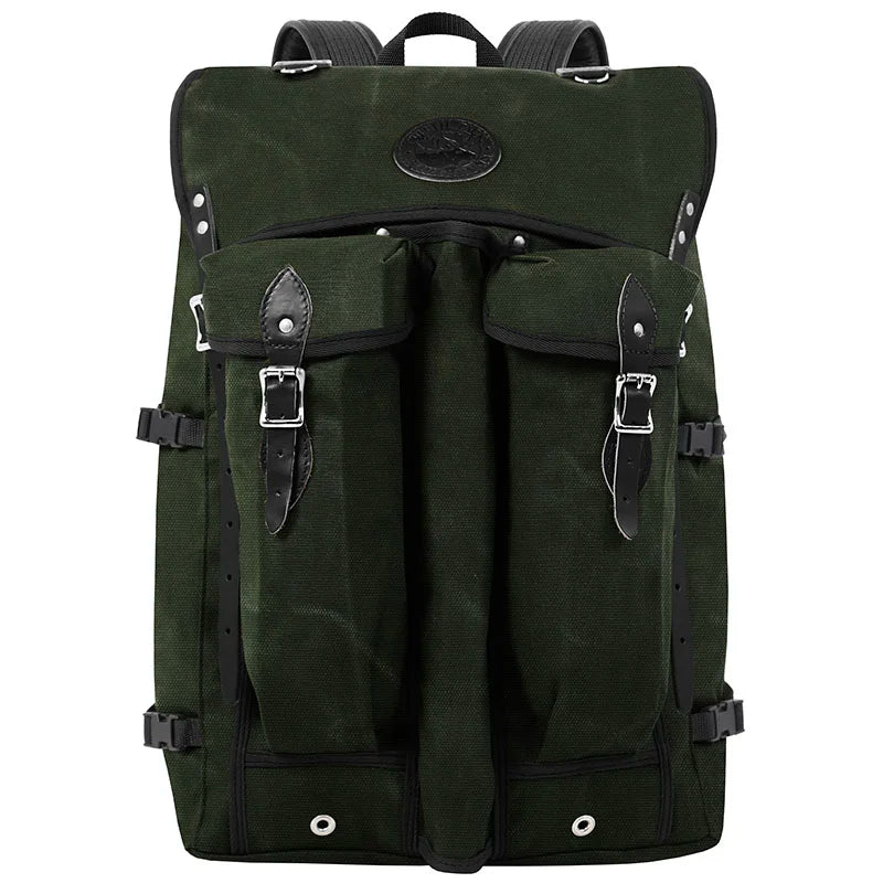 Bushcrafter backpack in rugged dark green canvas with leather accents, designed for durable outdoor use by Duluth Pack, ideal for hiking and bushcraft adventures.