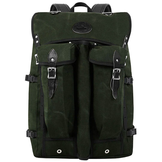 Bushcrafter backpack in rugged dark green canvas with leather accents, designed for durable outdoor use by Duluth Pack, ideal for hiking and bushcraft adventures.