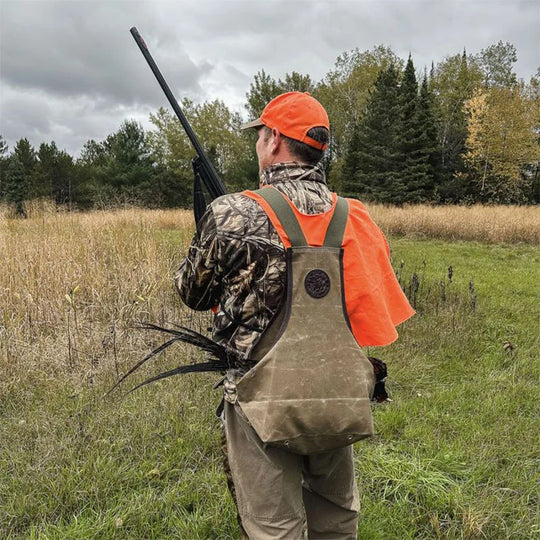 Wax Khaki Upland Game Vest on Model in Field with Pheasent