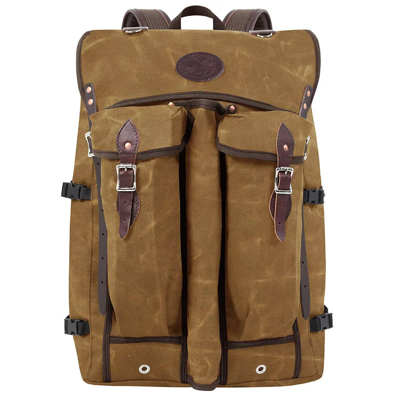 Bushcrafter rugged 15-ounce waxed canvas backpack with leather straps, designed for durable outdoor use by Duluth Pack.