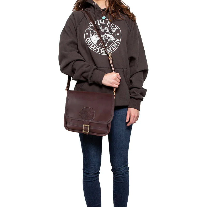 Leather Mini Haversack in premium American cowhide leather, shown worn crossbody by a model dressed casually, highlighting handmade craftsmanship from Duluth Pack.