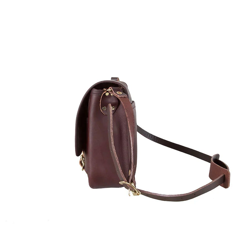 Leather Mini Haversack in premium American cowhide leather by Duluth Pack, showing side profile with adjustable leather strap for rugged outdoor use.