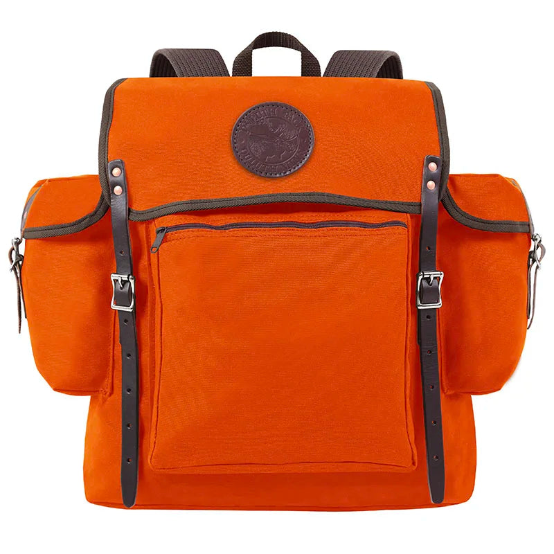 Rambler backpack in bright orange with black leather straps and front zippered pocket, crafted by Duluth Pack for durable outdoor use on hiking or canoe trips.