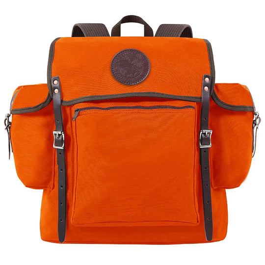 Rambler backpack in bright orange with black leather straps and front zippered pocket, crafted by Duluth Pack for durable outdoor use on hiking or canoe trips.