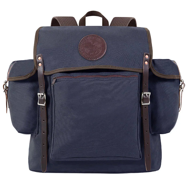 Rambler backpack in navy with leather straps and buckles, featuring durable handmade canvas for rugged outdoor use by Duluth Pack.