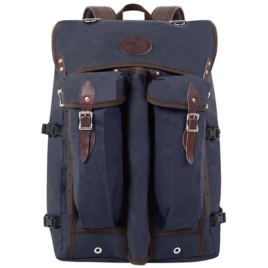 Bushcrafter backpack in navy rugged canvas with leather accents and buckle pockets, designed for durable outdoor use by Duluth Pack.