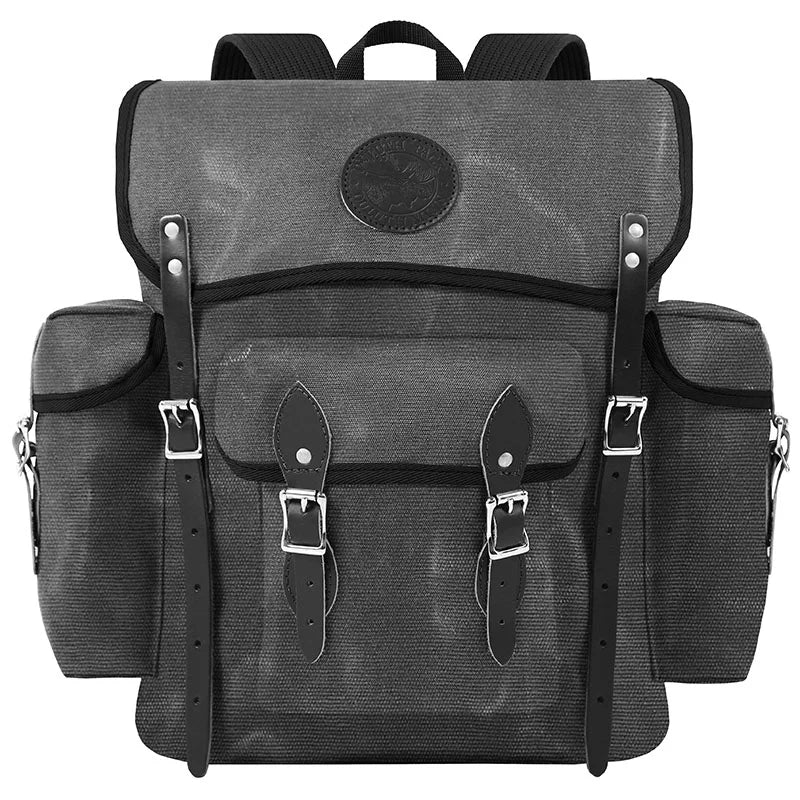 Wanderer backpack in waxed grey canvas with black riveted leather straps, designed for rugged outdoor use and durable everyday adventures.