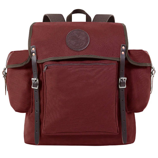 Rambler backpack in burgundy with leather straps, made of durable canvas for outdoor use, perfect for hiking or weekend trips by Duluth Pack.