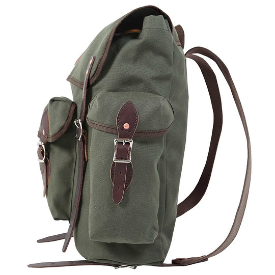 Wanderer backpack in Olive Drab featuring rugged canvas and hand-cut leather reinforcements, designed for outdoor adventures and durable use.
