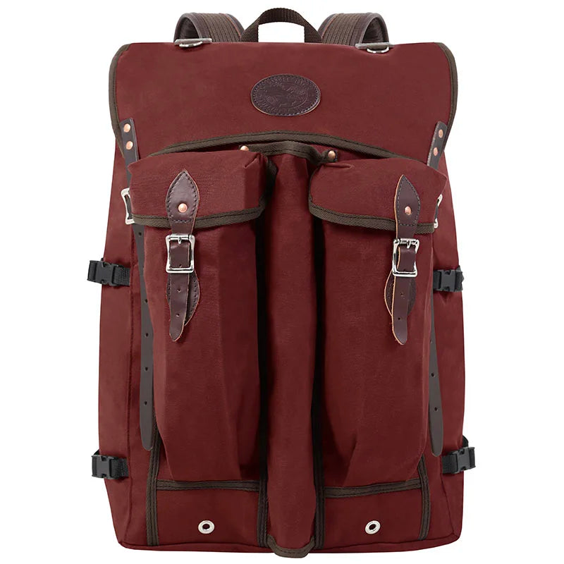 Bushcrafter backpack in rugged maroon canvas with leather accents, designed for durable outdoor use by Duluth Pack wilderness enthusiasts.