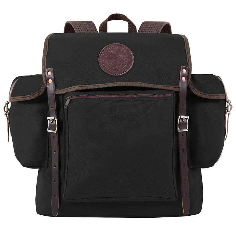 Rambler backpack in black canvas with leather straps and multiple pockets, designed for durable outdoor use and rugged adventures by Duluth Pack.