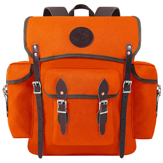Wanderer pack in bright orange rugged 15 oz canvas with hand-cut leather straps and silver buckles, designed for durable outdoor adventure use by Duluth Pack.