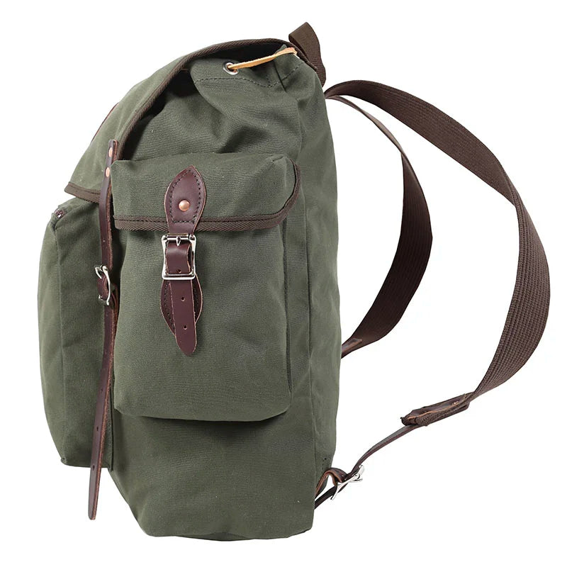 Rambler backpack in olive drab with leather straps, handmade canvas and leather design by Duluth Pack for rugged outdoor hiking and camping use.