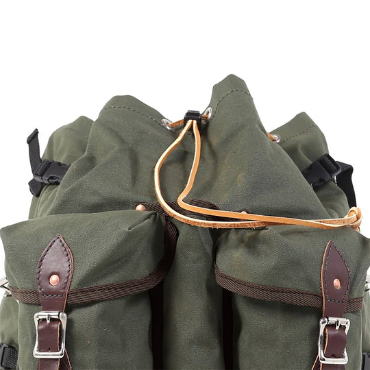 Bushcrafter backpack in rugged 15-ounce green canvas with leather accents, designed for durable outdoor use and reliable everyday carry.