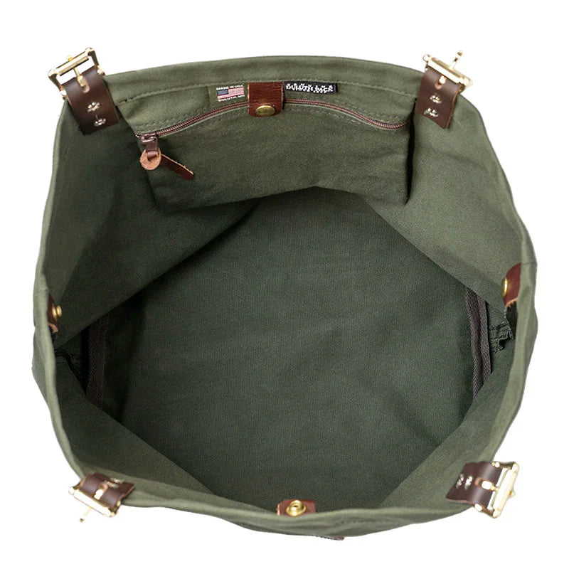 Market Tote in Olive Drab featuring rugged canvas interior with premium leather handles and antique brass hardware, designed for durable outdoor use by Duluth Pack.