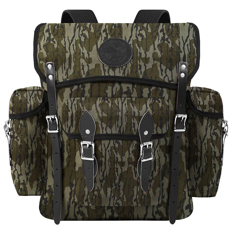 Wanderer backpack in Mossy Oak Bottomland Camo with rugged canvas and leather straps, designed for durable outdoor adventure by Duluth Pack.