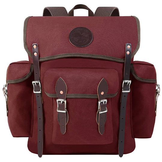 Wanderer backpack in burgundy made of rugged canvas with hand-cut leather straps and outdoor-ready design by Duluth Pack for durable adventures.