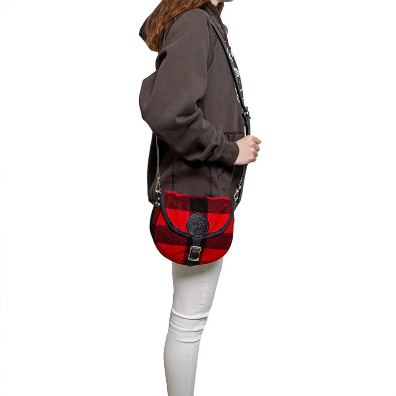 Classic Wool Small Shell Purse in red and black wool plaid with leather accents, shown worn crossbody for everyday outdoor and casual use.