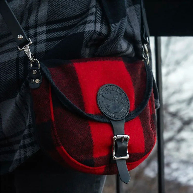 Classic Wool Small Shell Purse in red and black wool with leather strap and buckle, styled for outdoor use with durable craftsmanship heritage and rugged appeal.