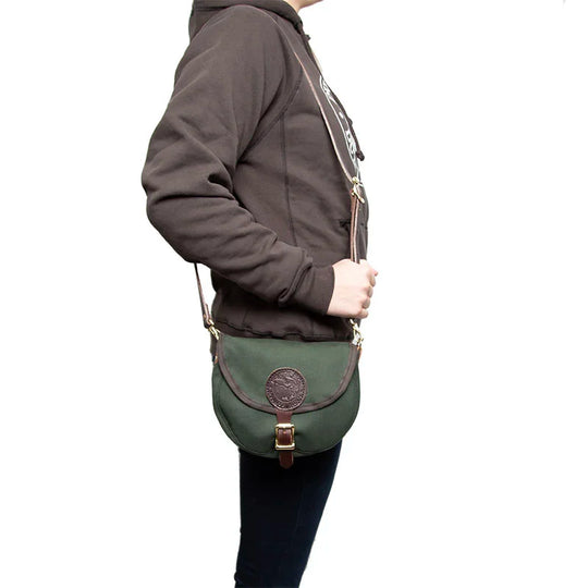Small Shell Purse in Olive Drab with adjustable premium leather shoulder strap, modeled for rugged outdoor use, showcasing Duluth Pack craftsmanship.