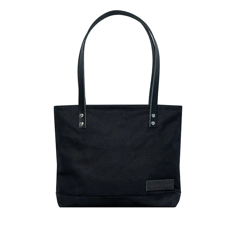 Superior Series Canvas Lakewalk Tote in black canvas with leather straps, a durable outdoor accessory blending heritage craftsmanship and rugged style.