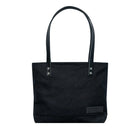 Superior Series Canvas Lakewalk Tote in black canvas with leather straps, a durable outdoor accessory blending heritage craftsmanship and rugged style.