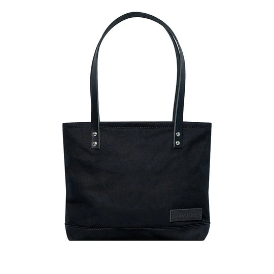 Superior Series Canvas Lakewalk Tote in black canvas with leather straps, a durable outdoor accessory blending heritage craftsmanship and rugged style.