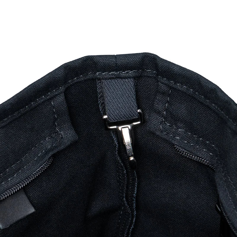 Superior Series Canvas Lakewalk Tote in dark canvas with leather trim showing interior clasp and reinforced stitching, highlighting durable outdoor craftsmanship.