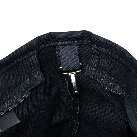 Superior Series Canvas Lakewalk Tote in dark canvas with leather trim showing interior clasp and reinforced stitching, highlighting durable outdoor craftsmanship.