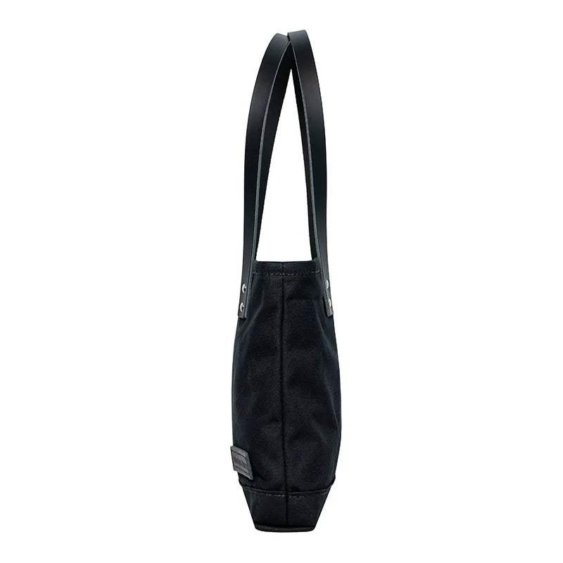 Superior Series Canvas Lakewalk Tote in black canvas with leather handles, showcasing durable craftsmanship ideal for outdoor use by Duluth Pack.