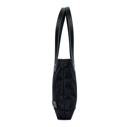 Superior Series Canvas Lakewalk Tote in black canvas with leather handles, showcasing durable craftsmanship ideal for outdoor use by Duluth Pack.