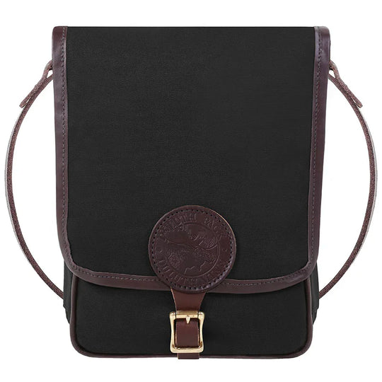 Haversack in rugged black 15-ounce canvas with premium leather trims and antique brass hardware, designed by Duluth Pack for durable outdoor use and classic style.