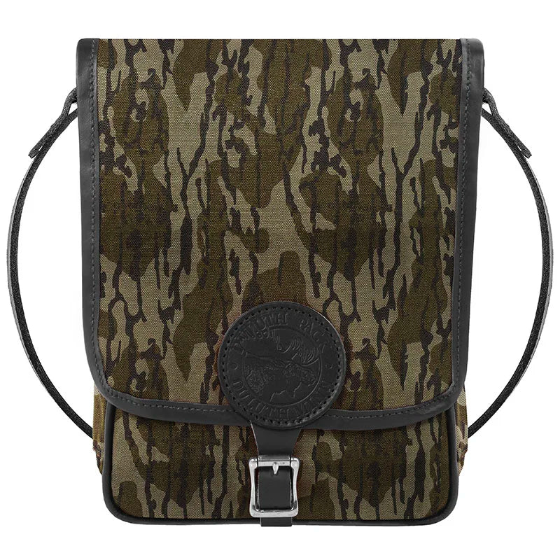 Haversack in rugged camouflage 15-ounce canvas with premium leather accents and durable roller buckle, ideal for outdoor use by Duluth Pack.