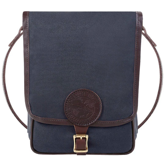 Haversack in rugged navy 15-ounce canvas with premium leather trim and brass hardware, designed by Duluth Pack for durable outdoor use and heritage craftsmanship.