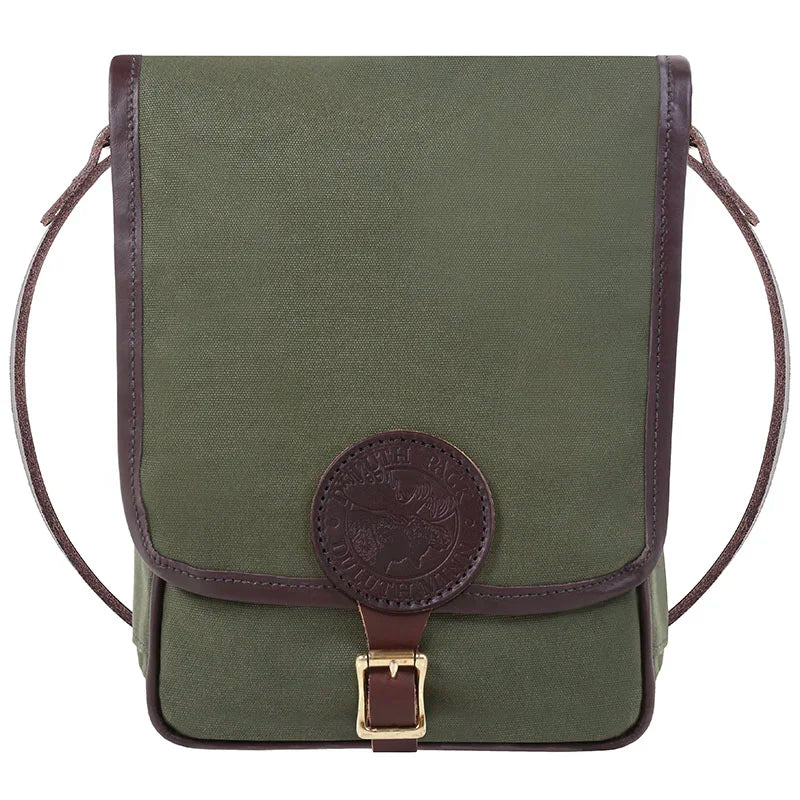 Haversack in rugged olive green 15-ounce canvas with premium leather trim and antique brass buckle, crafted by Duluth Pack for durable outdoor use.