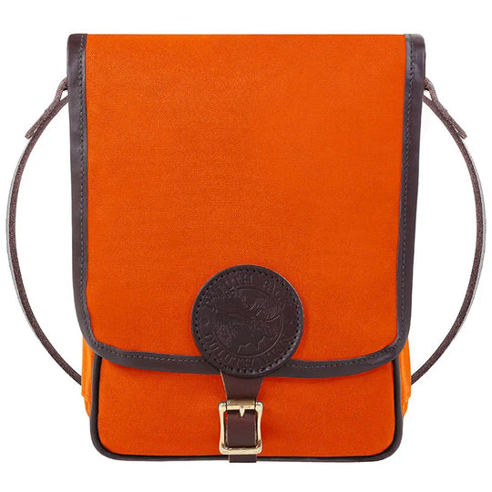 Haversack with rugged orange 15-ounce canvas and premium leather trim featuring antique brass hardware, designed by Duluth Pack for durable outdoor use.