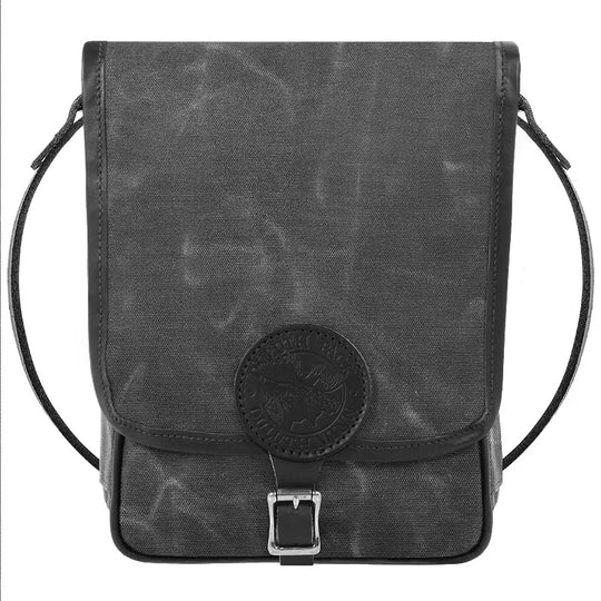 Haversack in rugged waxed gray canvas with premium leather accents and antique brass hardware, designed for durable outdoor use by Duluth Pack.