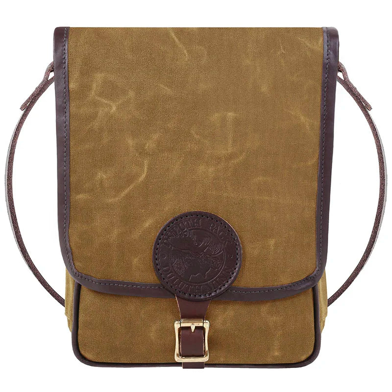 Haversack in rugged waxed canvas and premium leather with brass buckle, designed by Duluth Pack for durable outdoor use.
