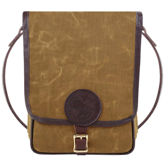 Haversack in rugged waxed canvas and premium leather with brass buckle, designed by Duluth Pack for durable outdoor use.