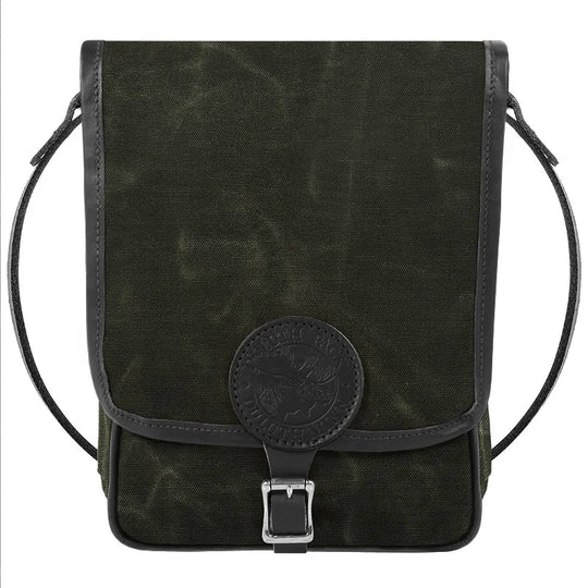 Haversack in rugged waxed olive canvas with premium leather trim and antique brass hardware, designed by Duluth Pack for durable outdoor use.