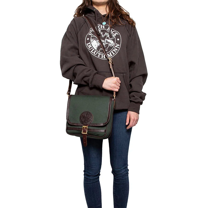 Mini Haversack Purse in Olive Drab with premium leather and roller buckle, shown worn casually for everyday use and travel outdoors