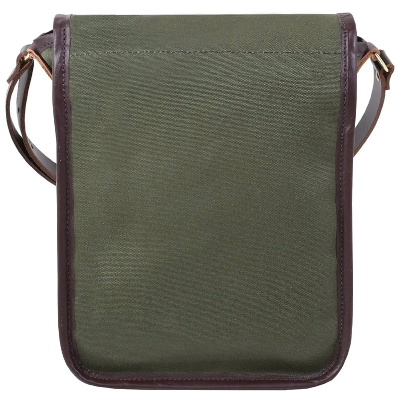 Haversack in rugged olive green 15-ounce canvas with premium leather trim and adjustable strap, designed for durable outdoor use by Duluth Pack.