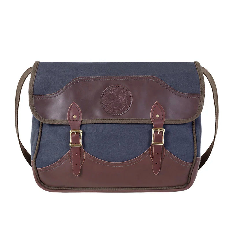 Deluxe Book Bag in navy with handcrafted leather trim and durable brass hardware, showcasing heritage craftsmanship ideal for rugged outdoor use.