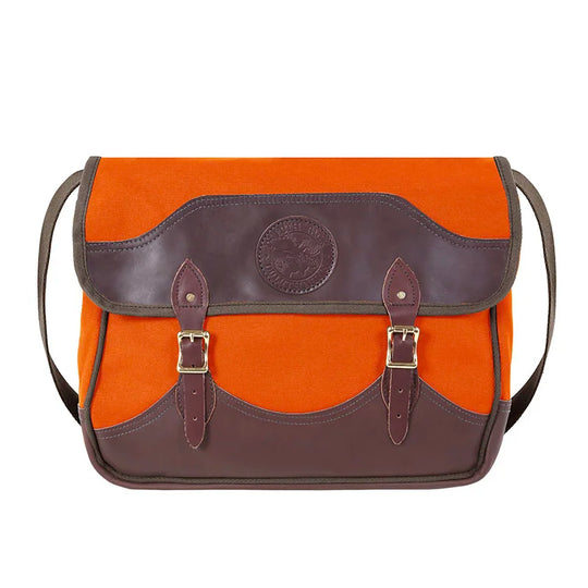 Deluxe Book Bag in bright orange with handcrafted leather trim and antique brass hardware, designed for durable outdoor use by Duluth Pack.