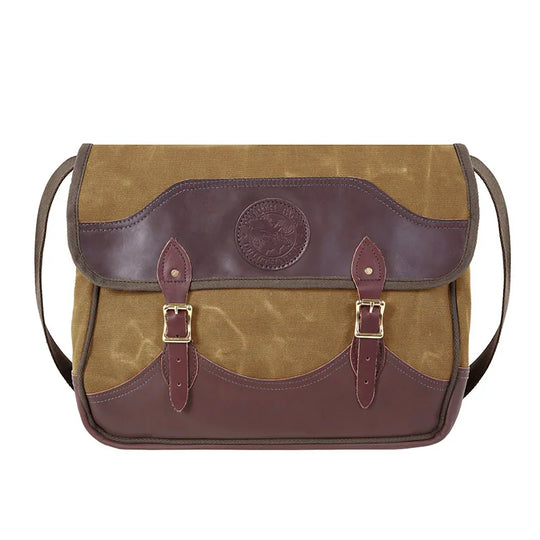 Deluxe Book Bag in waxed khaki canvas with handcrafted leather trim and brass hardware, showcasing durable outdoor craftsmanship from Duluth Pack.