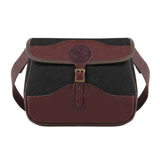 Field Satchel in black rugged 15-ounce canvas with premium brown leather trim and antique brass hardware, ideal for durable outdoor use by Duluth Pack.