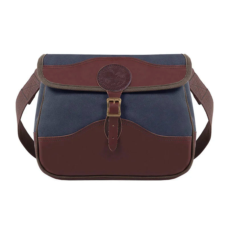 Field Satchel in navy rugged 15-ounce canvas with thick premium leather trim and antique brass hardware, designed for durable outdoor use by Duluth Pack.