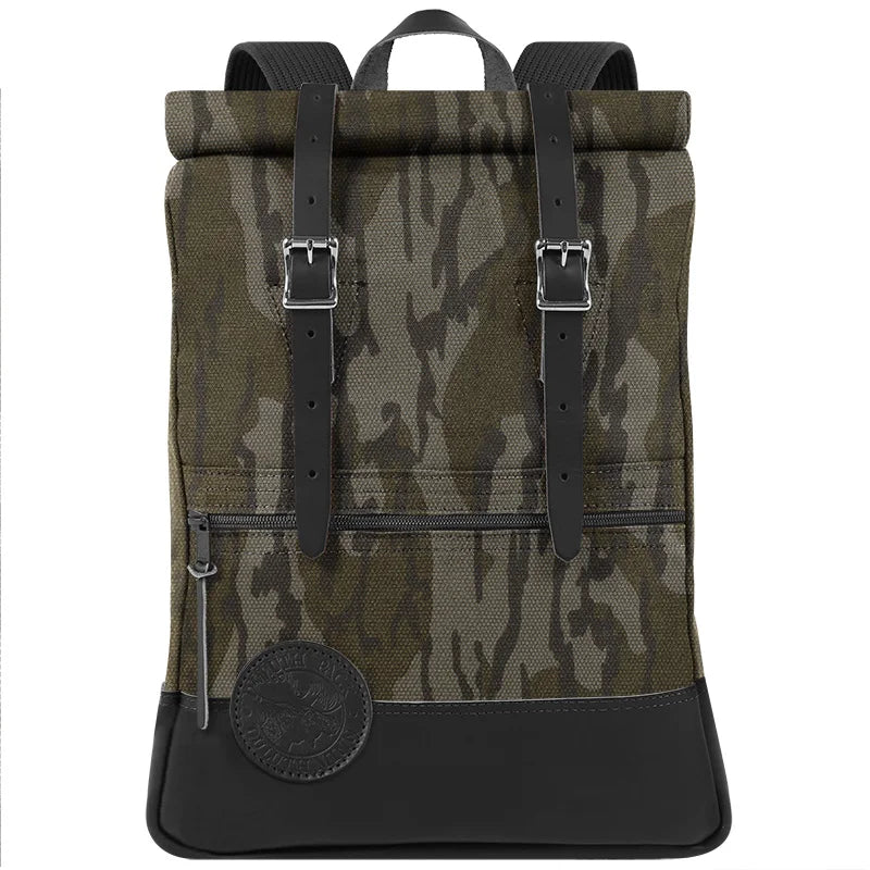 Deluxe Roll-Top Scout Pack in Mossy Oak Bottomland Camo with leather accents, crafted by Duluth Pack, designed for rugged outdoor use and durable canvas performance.